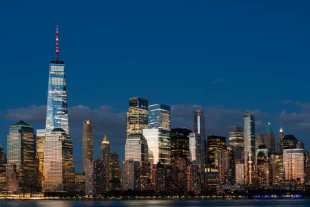 Lights of New York skyscrapers, office buildings at night, financial corporation. Manhattan skyline skyscrapers in the eveningの写真素材
