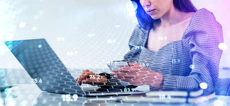Businesswoman working with laptop and smartphone, cryptocurrency hologram with cells and chains, numbers, bokeh lights. Concept of e-businessの写真素材