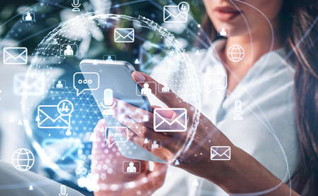 Office woman typing in phone in hands, close up, double exposure hud of e-mails and social media....
