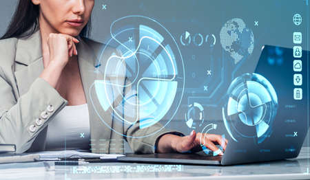 Office woman working using computer, double exposure, financial data and business bar chart. Graph lines and earth sphere. Concept of worldwide businessの写真素材