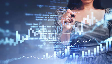 Office woman hand with pen, point at hud with stock market dynamics, bar chart, double exposure with glowing script. Concept of financial app and traderの写真素材