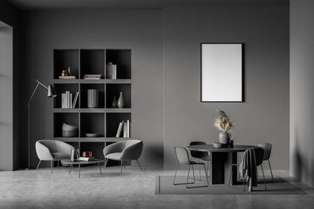 Dark waiting room interior with two armchairs and bookshelf, built-in shelf and decoration, table with four chairs on gray concrete floor and carpet. Blank canvas mock up on wall, 3D renderingの写真素材