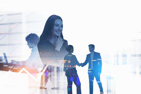 Group of business people work together shaking hands and typing on laptop. City skyscraper in the background. Concept of teamwork and cooperation between colleagues in companyの写真素材
