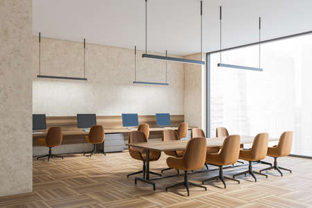 Light coworking room interior with brown armchairs and computers on table, side view, parquet floor. Office minimalist waiting room, window with skyscrapers, 3D renderingの写真素材