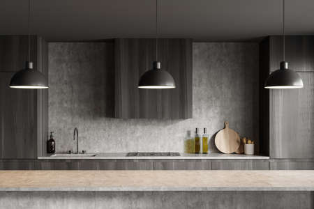 Stylish cooking interior with long gray table, lamps and sink with kitchenware, front view. Luxury kitchen with minimalist furniture, 3D renderingの写真素材