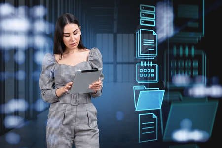 Businesswoman working with tablet, digital screen with document icons. Cloud storage of personal data information, online database. Concept of electronic documentsの写真素材