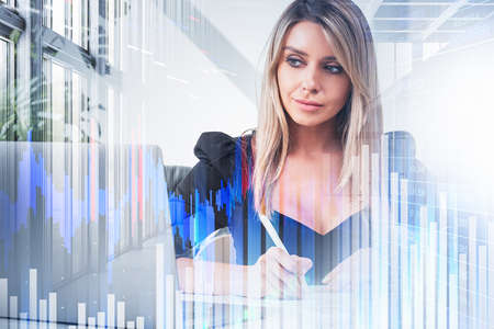 Woman take note in business papers looking at computer screen, double exposure with blue rising lines and financial chart. Concept of analysis and reportの写真素材