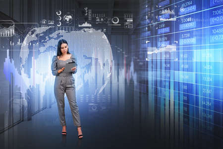 Office woman working with electronic devices. Digital hud earth globe with stock market changes, forex data numbers, icons and information. Concept of big dataの写真素材