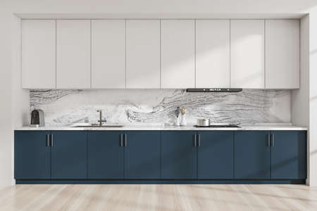 Modular kitchen cabinet interior with minimalist blue and white design and marble look splashback. Light wood floor. Concept of modern house design. 3d renderingの写真素材