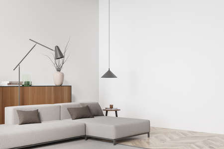 Bright living room interior with empty white wall, large sofa, coffee table, sideboard, lamp and...