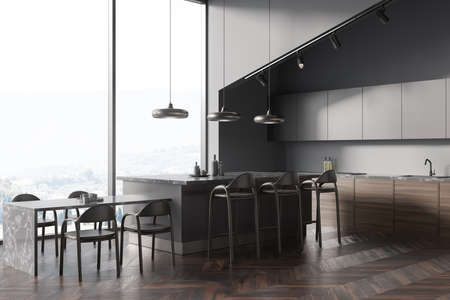 Eating interior with dark wooden chairs and table with dishes and stove with sink on deck, side view, panoramic window on countryside. Modern kitchen with parquet floor, 3D renderingの写真素材