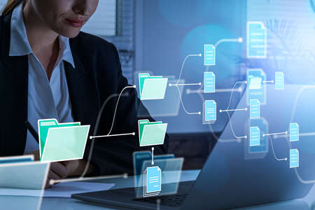 Businesswoman working with computer, look at the screen in office room. Folders with document icons....