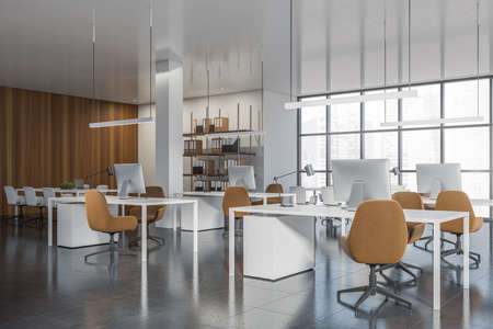 Corner view on bright office room interior with panoramic window with Singapore city view,...