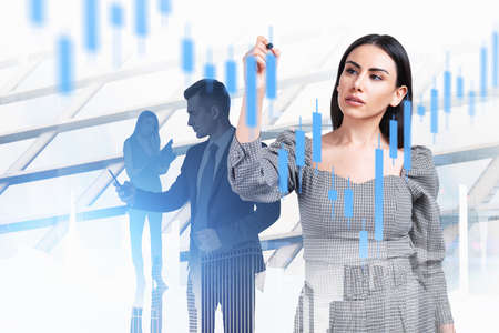 Businesswoman wearing formal dress works together with businessman typing on smartphone and touching...