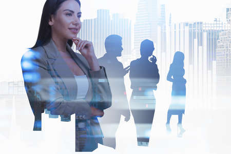 Office woman smiling and thoughtful look, people silhouette with New York skyscrapers. Financial icons and bar chart hologram. Concept of teamwork and start upの写真素材