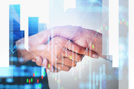 Businesswoman wearing formal suit is shaking hands with colleague. Office workplace with financial...