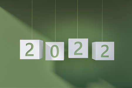 2022 New Year hanging on strings. White cubes with numbers on green background. Concept of future...