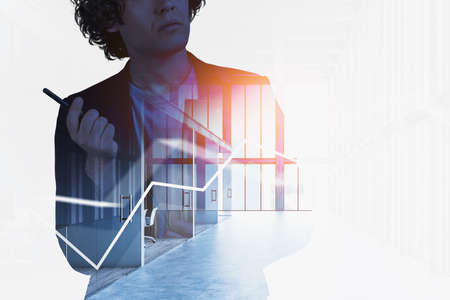Businessman silhouette with pen in hand, thinking and concentrated. Double exposure with office hall...