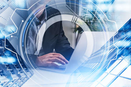 Businessman wearing formal suit is working and typing on laptop. Digital interface with circle...