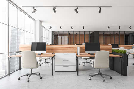 Bright office room interior with desktops, desks, armchairs, panoramic windows with Singapore city skyscrapers, concrete floor, glass partition. Place for working process and coworking. 3d renderingの写真素材