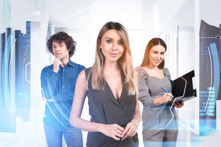 Businesswoman wearing formal wear works together with colleague taking notes on clipboard. office workplace in the background. Concept of teamwork, cooperation, coworking and partnershipの写真素材