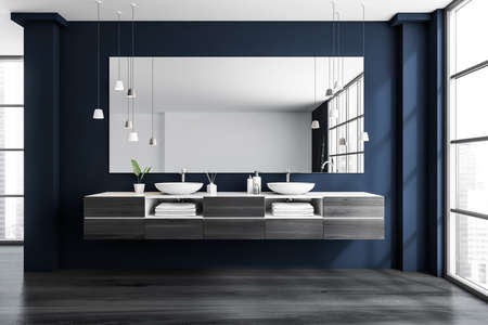 Blue bathroom interior with two sinks and mirror, bathing accessories on deck and towels in shelf....