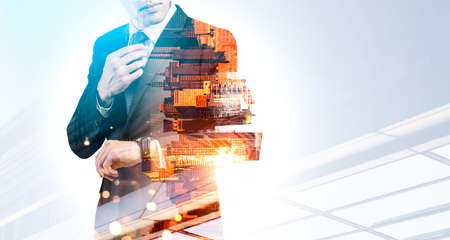 New York city skyscraper downtown panoramic view. Businessman wearing formal suit is watching at watches. Concept of working process of successful business peopleの写真素材