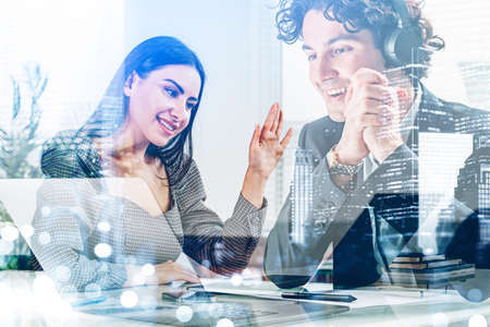 Businessman and businesswoman smiling, using laptop for a video call. Woman greeting and man in...