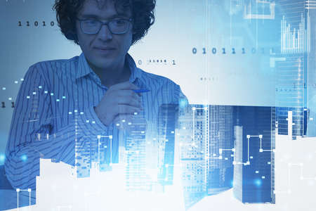 Man student programmer using laptop. Stock market dynamics and binary hologram. Business building,...