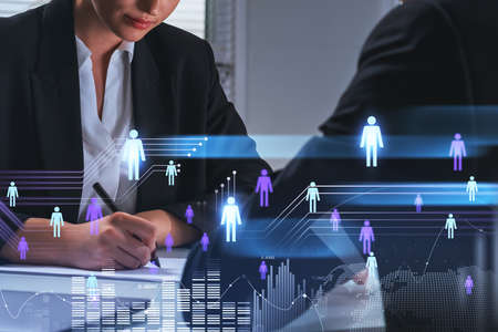 Businesswoman take note with pen, glowing hologram of people network, earth globe and statistics, double exposure, recruitment and communication. concept of interviewの写真素材