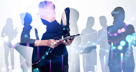 Office people silhouettes, boss woman in black dress holding device. Stock market graph changes, double exposure, teamwork. Concept of network and communicationの写真素材