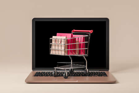 Laptop on beige background, shopping cart with different packages on keyboard. Concept of sale and purchase. Delivery of online orders. 3D renderingの写真素材