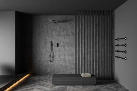 Wooden bathing room interior with shower and bench with towel, gray hardwood floor. Towel rail ladder on gray wall, front view. Stylish washing room with minimalist furniture. 3D renderingの写真素材