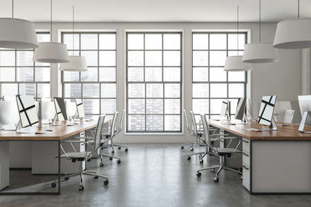 Side view on bright office room interior with desks with desktops, armchairs, panoramic windows and concrete floor. Concept of place for working process and coworking. 3d renderingの写真素材
