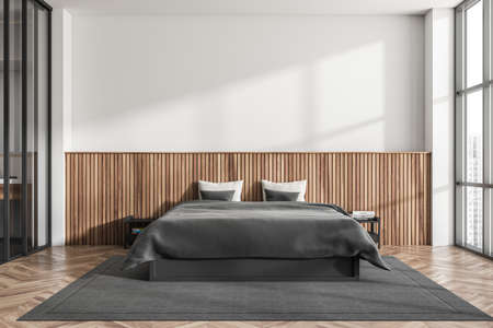 Light bedroom interior, bed with black linens and pillows, front view, carpet on hardwood floor. Panoramic window with city view. Copy space empty white wall. 3D renderingの写真素材