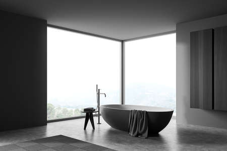 Bathing room interior with floor mounted mixer, bathtub on gray concrete floor. Washing room with...