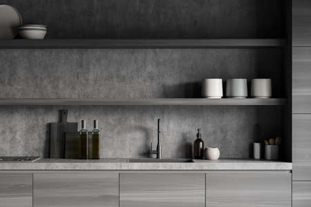 Black wooden kitchen interior with countertop and sink, deck with kitchenware, front view. Rack with decoration, oil bottle, soap and appliances, 3D renderingの写真素材