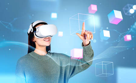 Businesswoman in casual wear is wearing vr helmet. Geometric figures and line connections in the...
