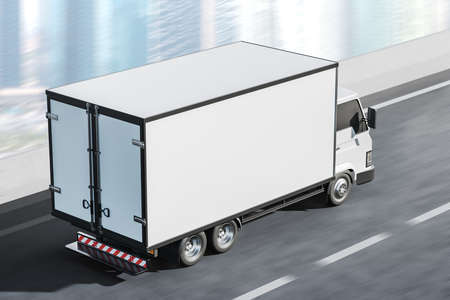White truck for delivery service moving on asphalt road, background of business city view, skyscrapers. top view. Concept of shipment. Mock up copy space for text and logo. 3D renderingの写真素材