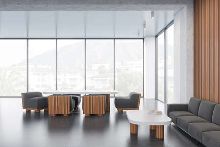 Meeting room interior with sofa and armchairs with table, coffee table on gray concrete floor....