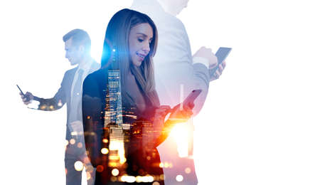 Business people working, using phone, smiling and typing. Double exposure with New York skyscrapers...