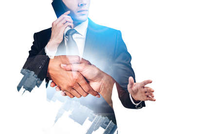Businessman have a business call, double exposure with handshake and New York cityscape. Concept of teamwork and partnership. Mockup copy spaceの写真素材