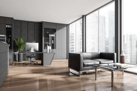 Corner view on dark office room interior with desktop, shelves, sofa, panoramic windows with skyscraper view and wooden floor. Concept of place for working process and meeting. 3d renderingの写真素材