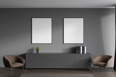 Dark guest room interior in office, two armchairs and documents on commode, carpet on brown hardwood floor. Two mock up copy space posters. 3D renderingの写真素材