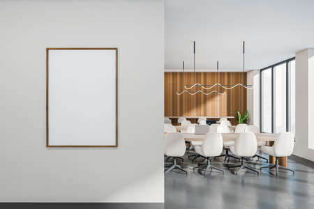 Front view on bright office room interior with empty white poster, panoramic windows with   view,...