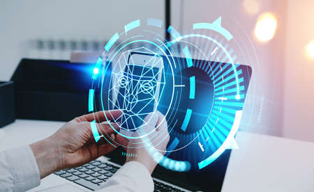 Businessman hands with smartphone, facial recognition hologram, biometric verification technology....
