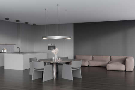 Dark kitchen interior with corner sofa and chairs, dining table on hardwood floor. Chill zone and...