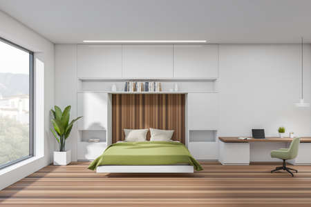 White bedroom interior with bed on hardwood floor, shelf with books and plant. Workplace with...