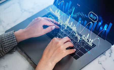Office woman hands typing on laptop, stock market diagrams, hologram with lines and candlesticks,...