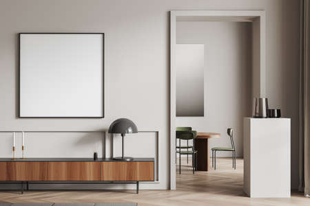 Light lounge zone interior with chairs and table, dresser with art decoration, stand with vase on hardwood floor. Mock up blank poster, 3D renderingの写真素材